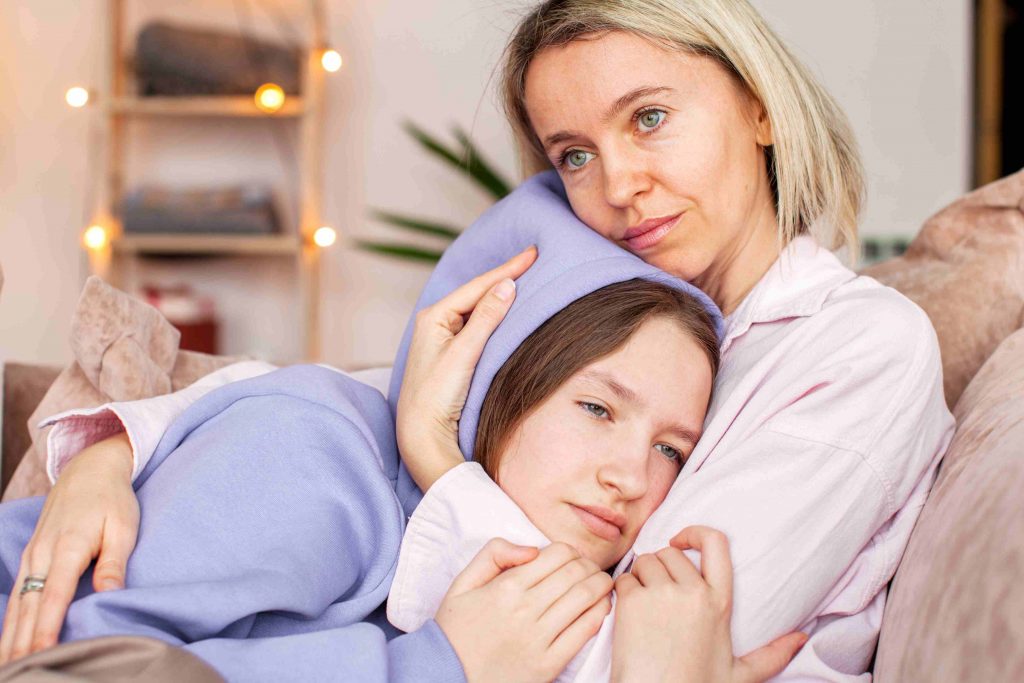 Parent comforting a child during cancer care